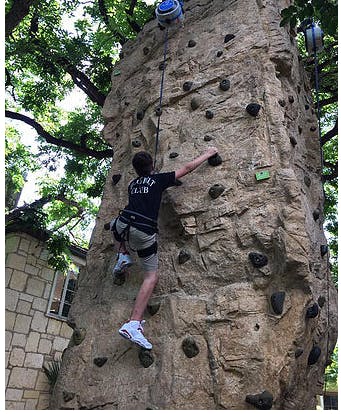 Child rock climbing outdoors