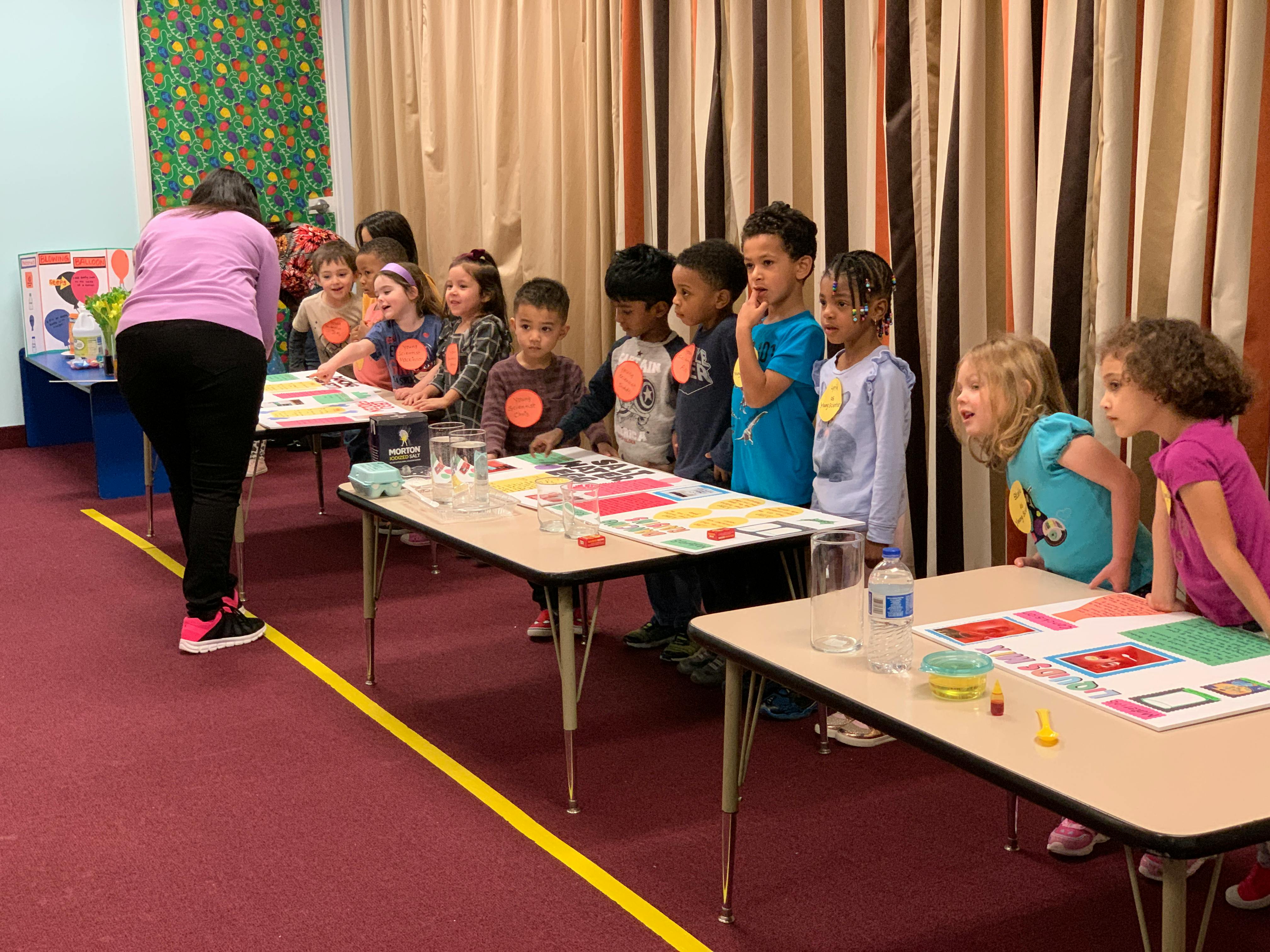 Person teaching a group of children in a classroom