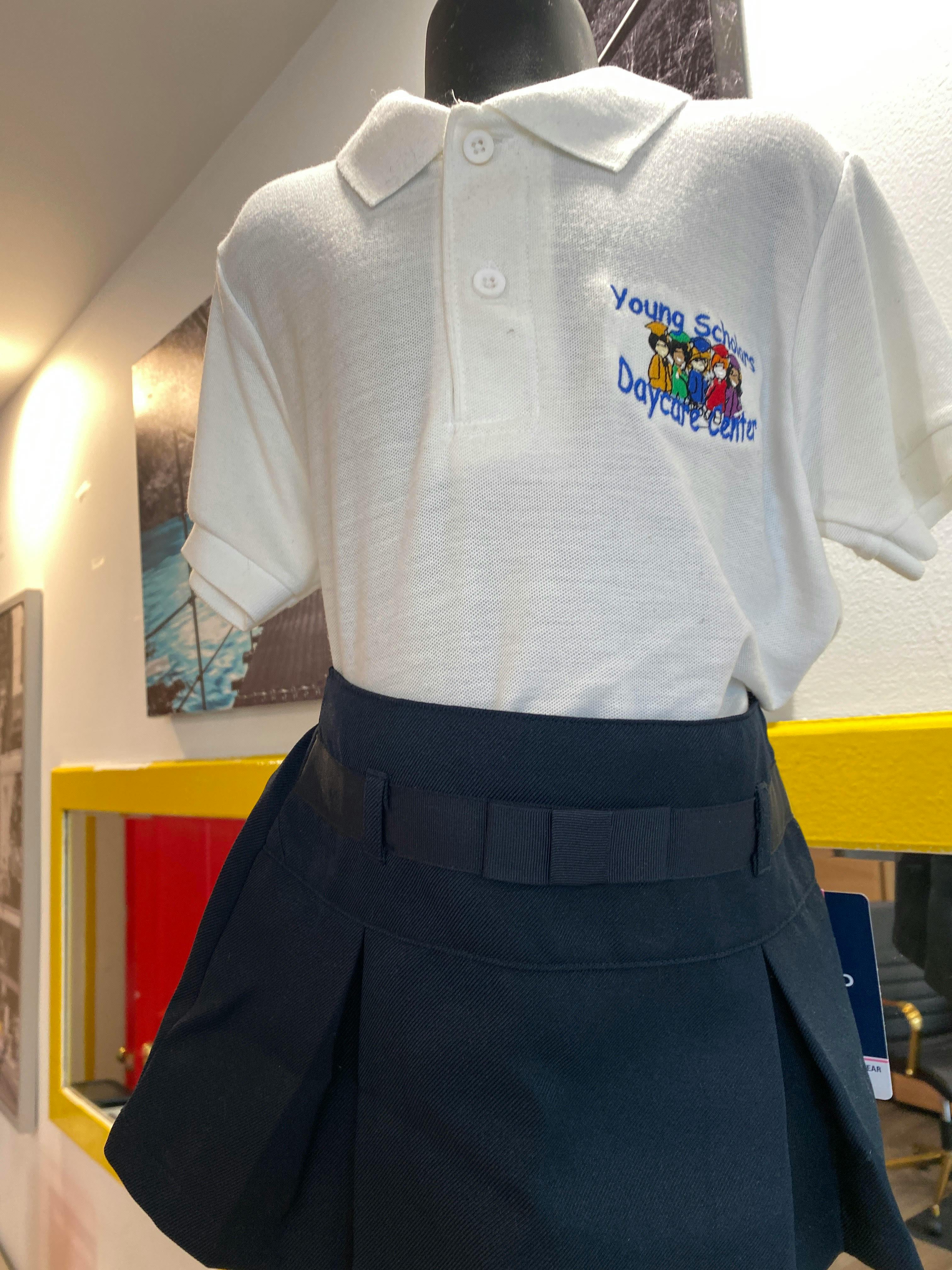 White polo shirt with "Young Scholars Daycare Centre" logo and navy blue skirt
