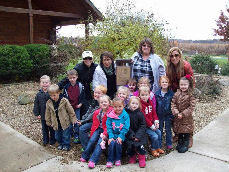 Group of adults and children posing outdoors