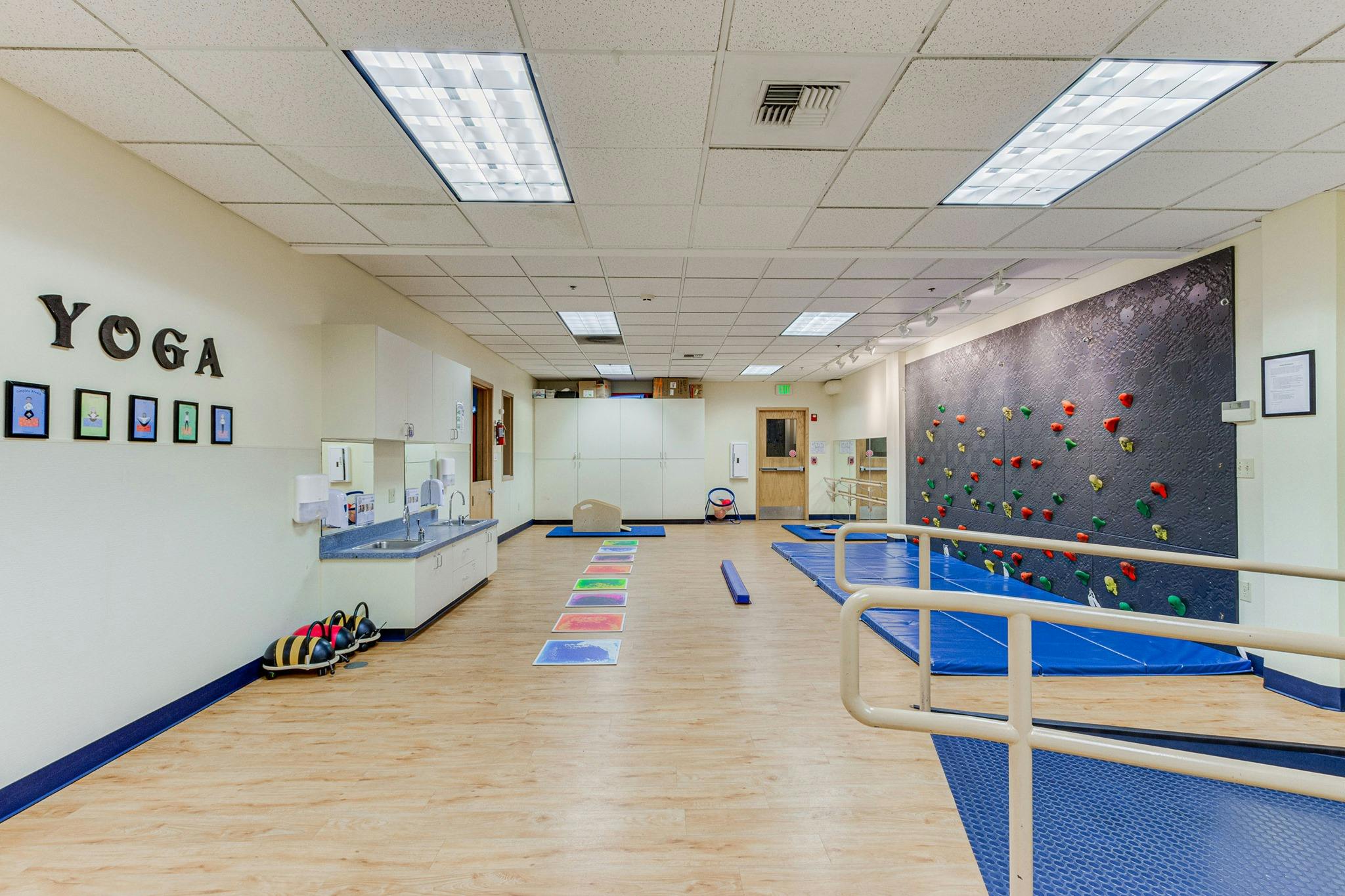 Yoga studio with a climbing wall and exercise mats