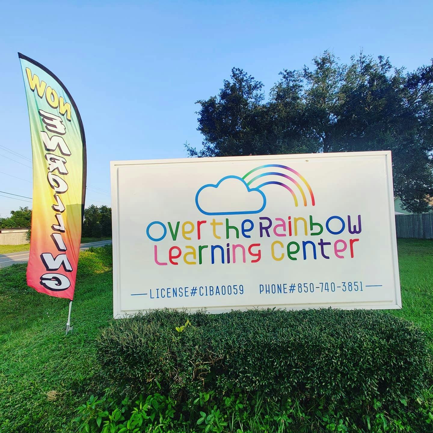 Sign for Over the Rainbow Learning Center with a rainbow flag