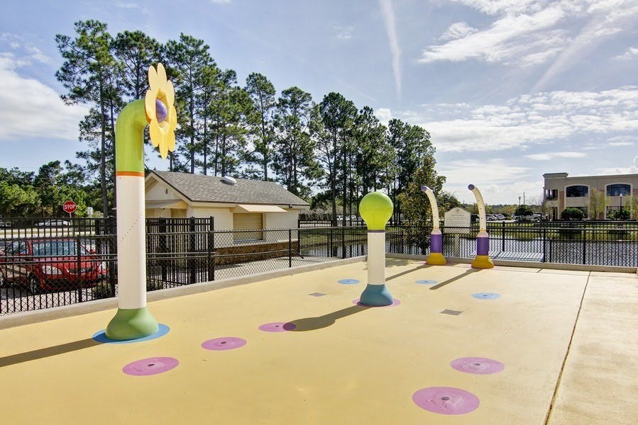 Outdoor splash pad with colorful water features