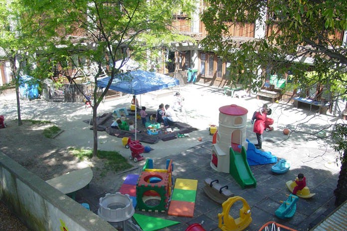 Outdoor playground with children playing on slides and other equipment
