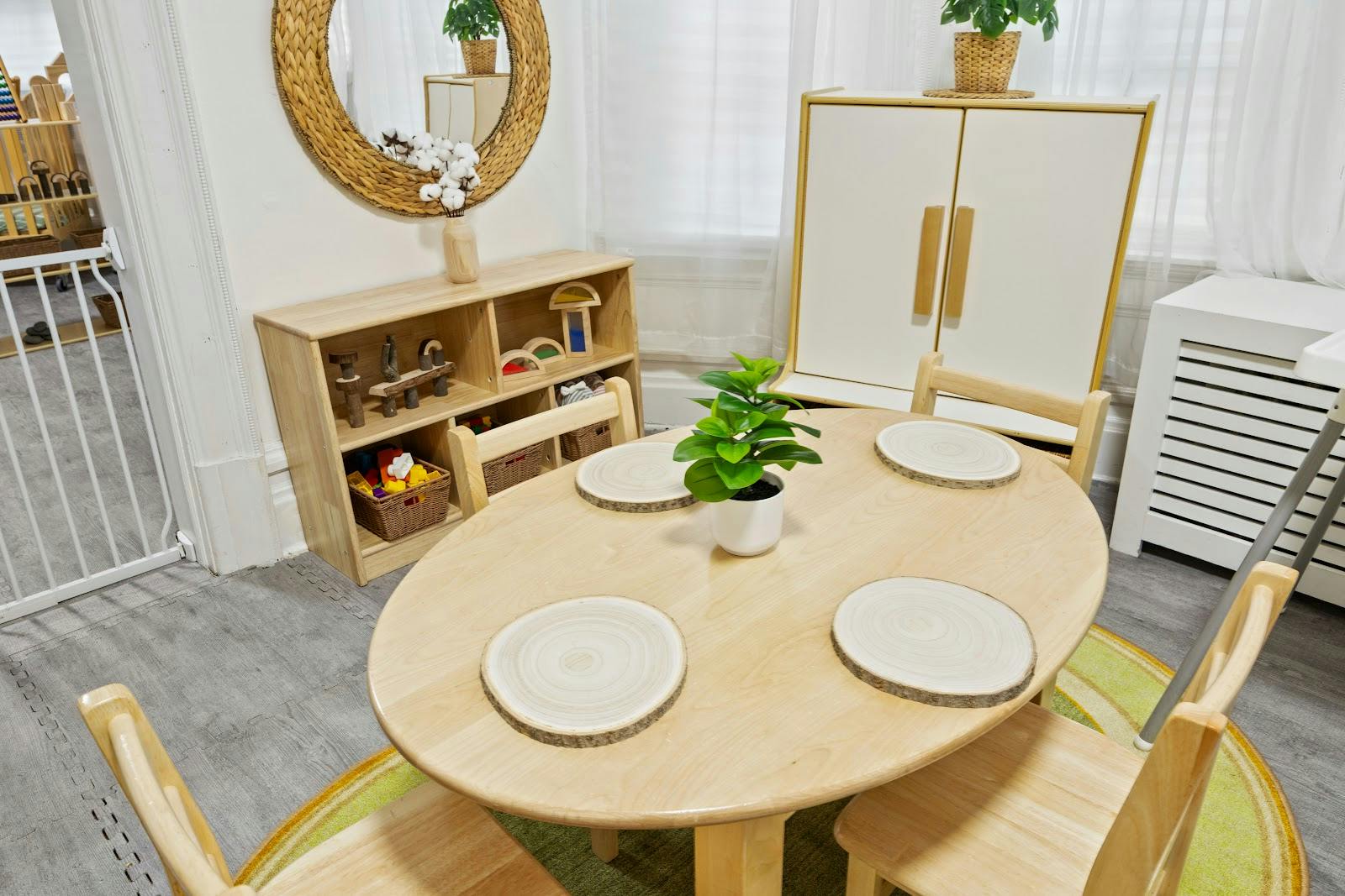 Wooden children table and chairs in a classroom with toy storage shelves