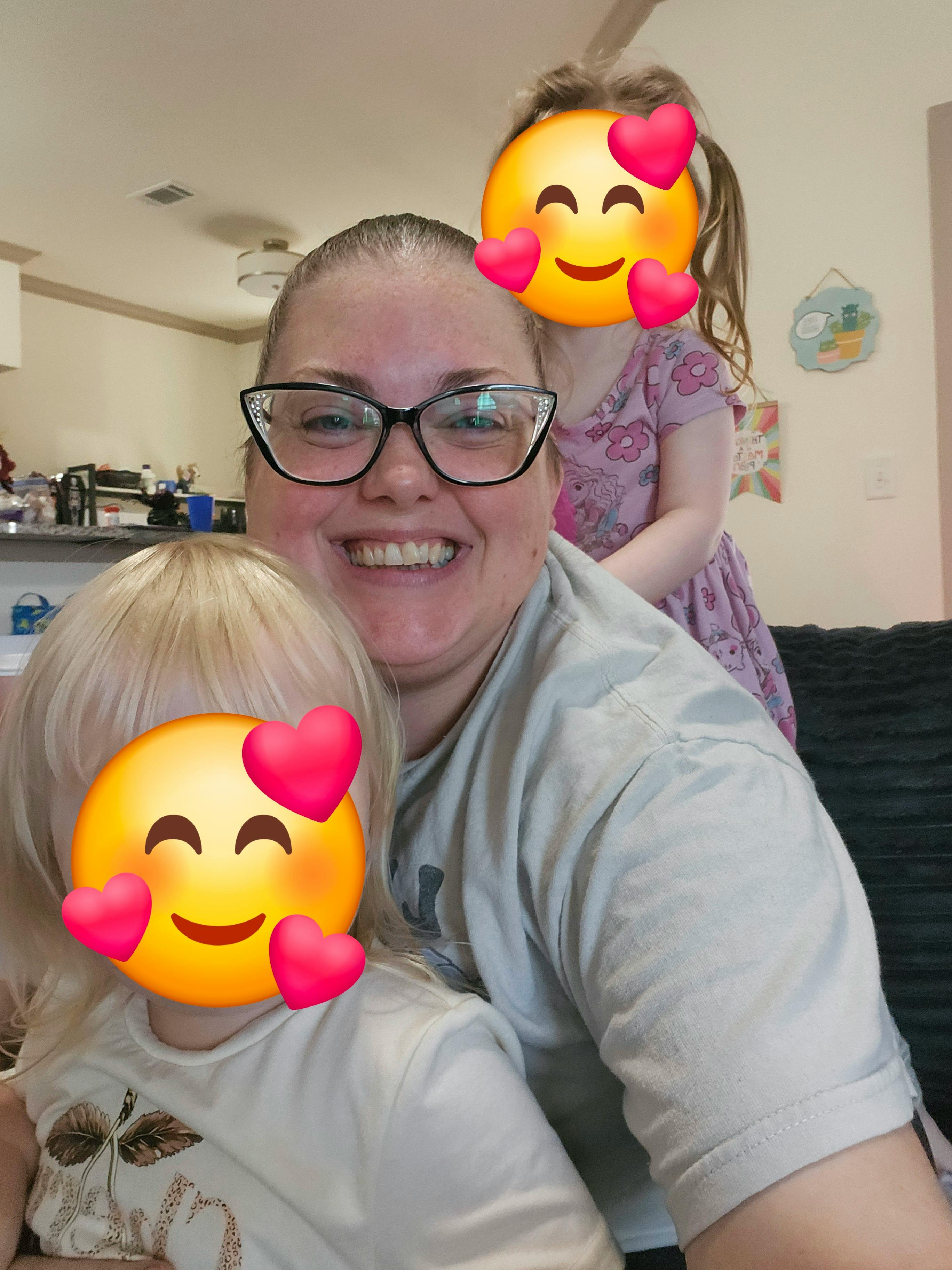 Adult and two children posing for a photo indoors
