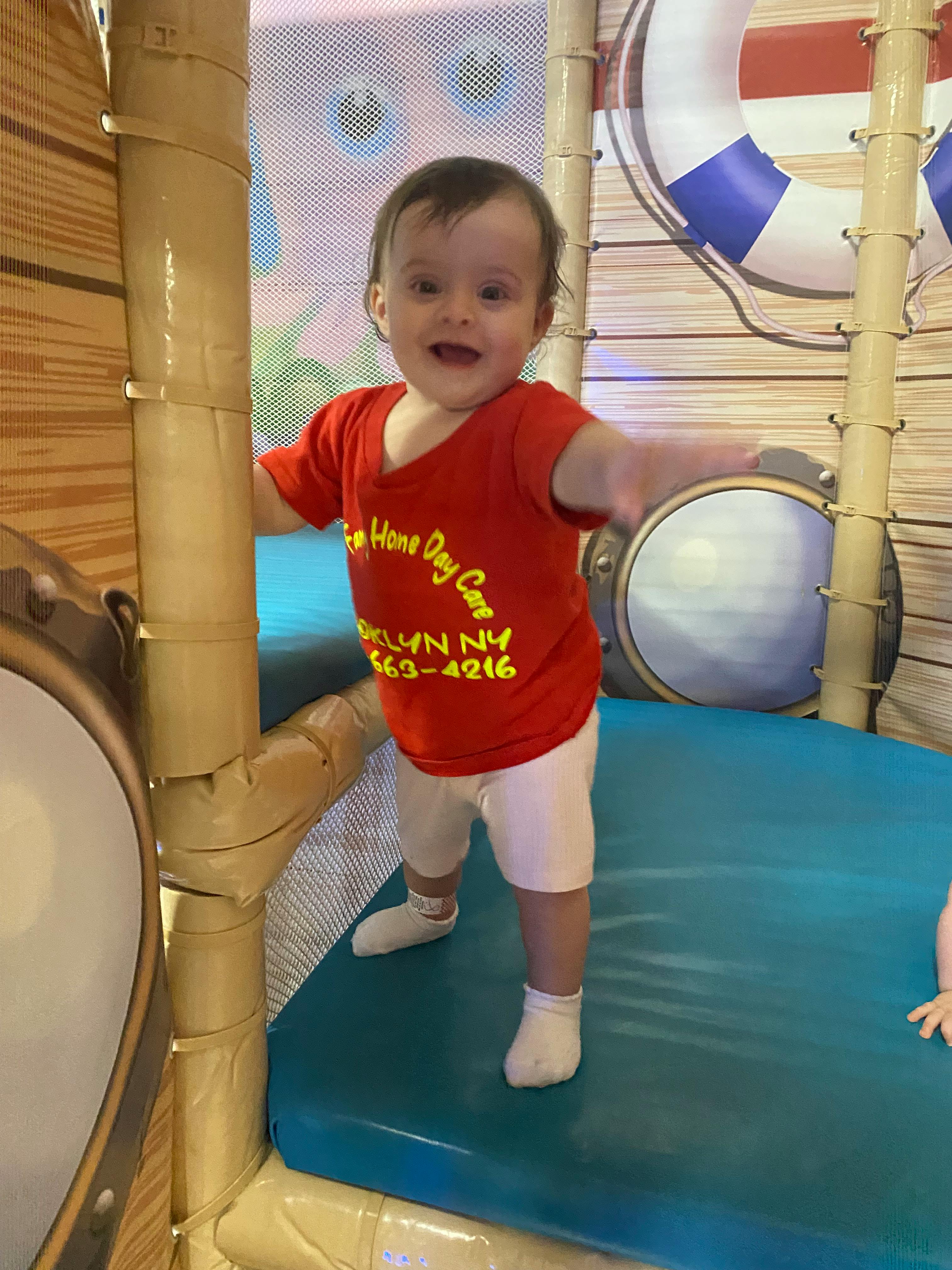 Child standing in an indoor soft play area