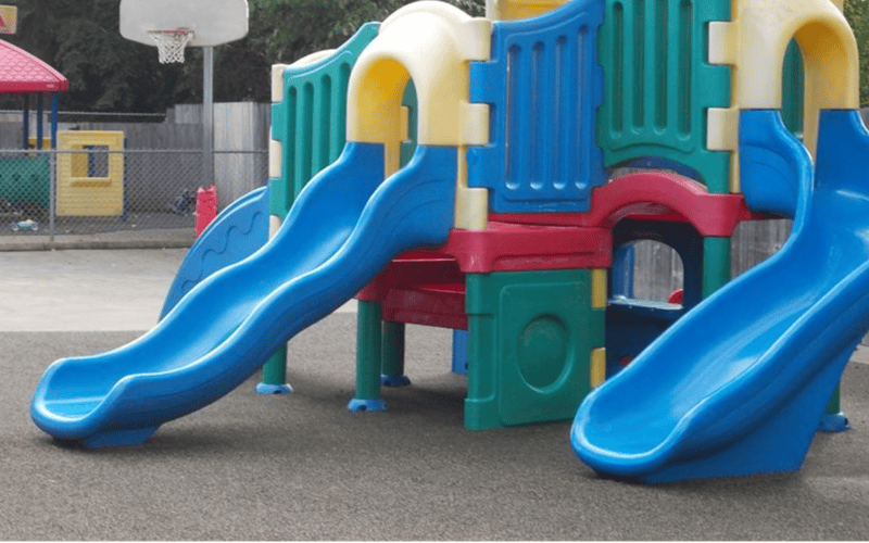 Colorful playground structure with multiple blue slides