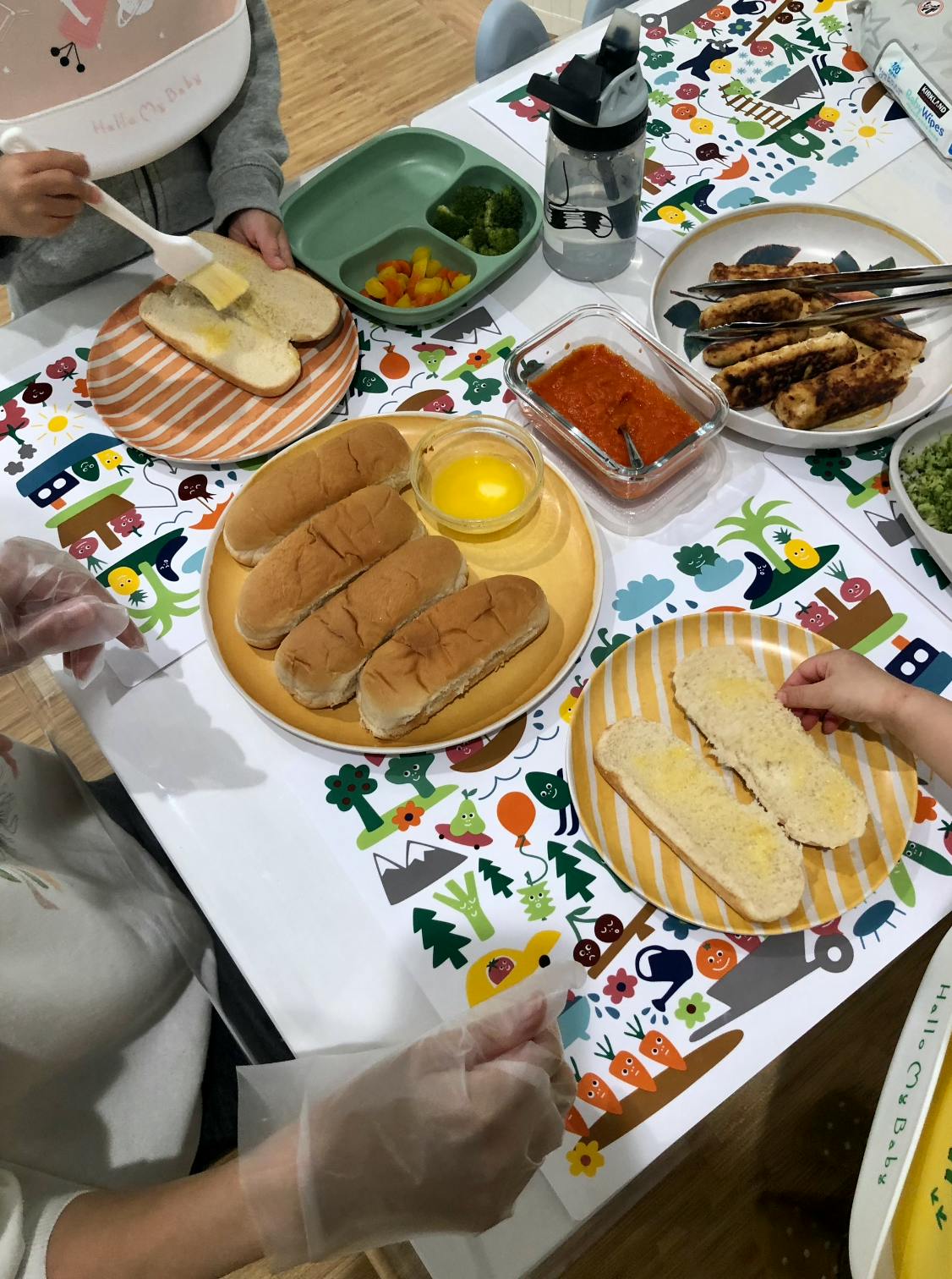 People preparing food on a table with various dishes
