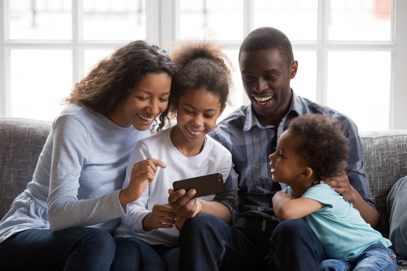 People and two children looking at a phone
