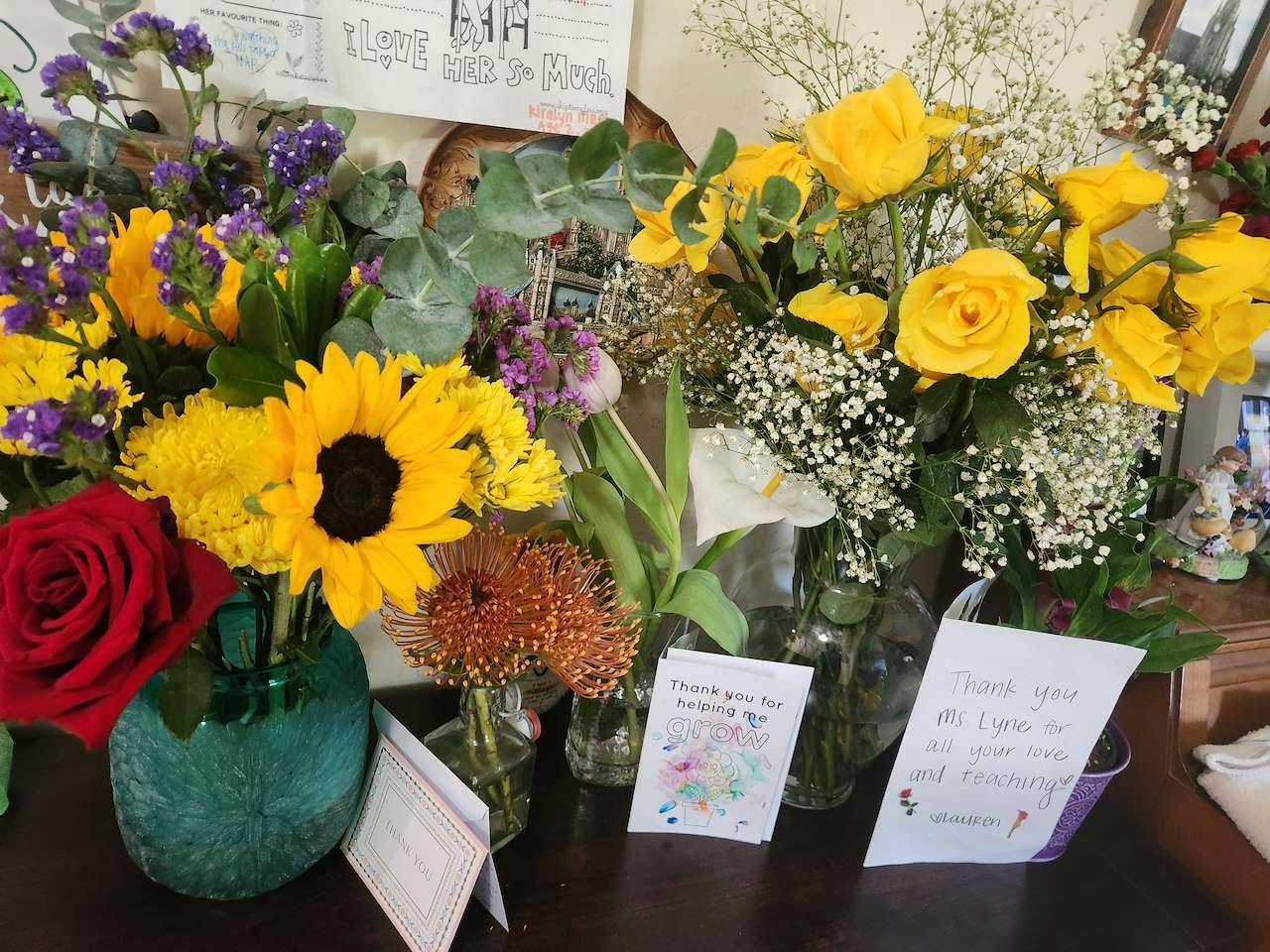 Bouquets of flowers and thank you notes on a table