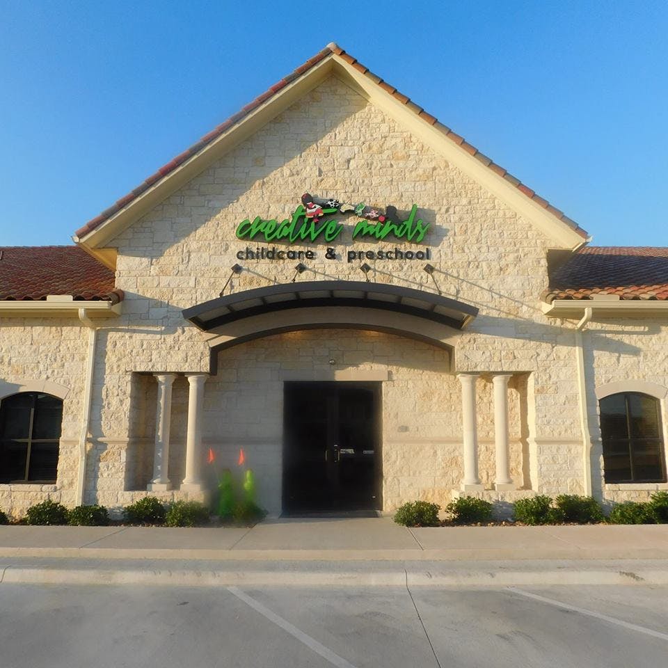 Building with "Creative Minds Childcare & Preschool" sign