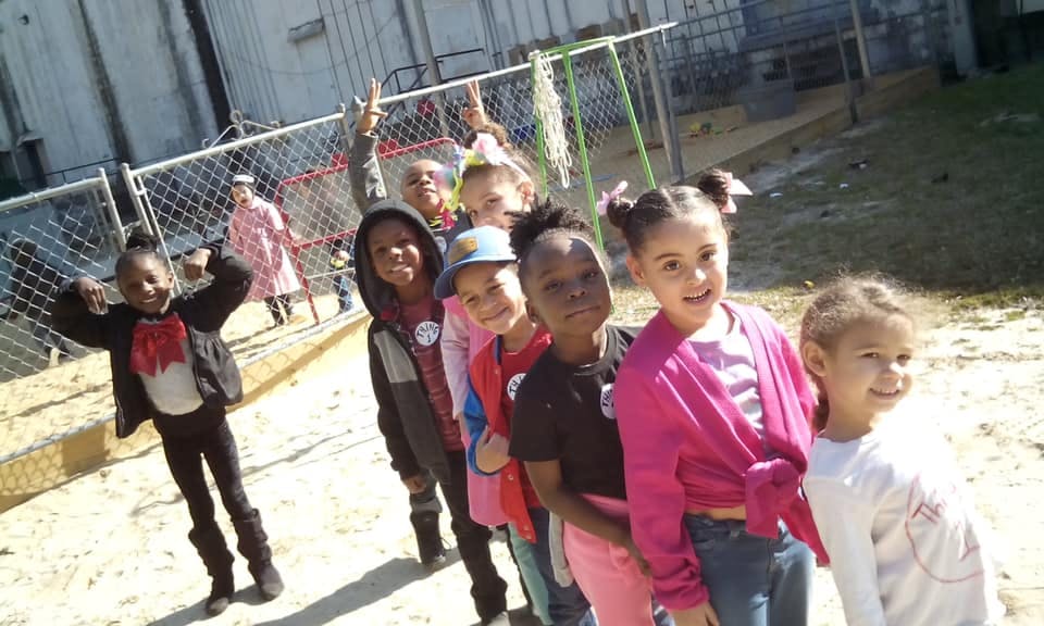 Children standing in a line outdoors