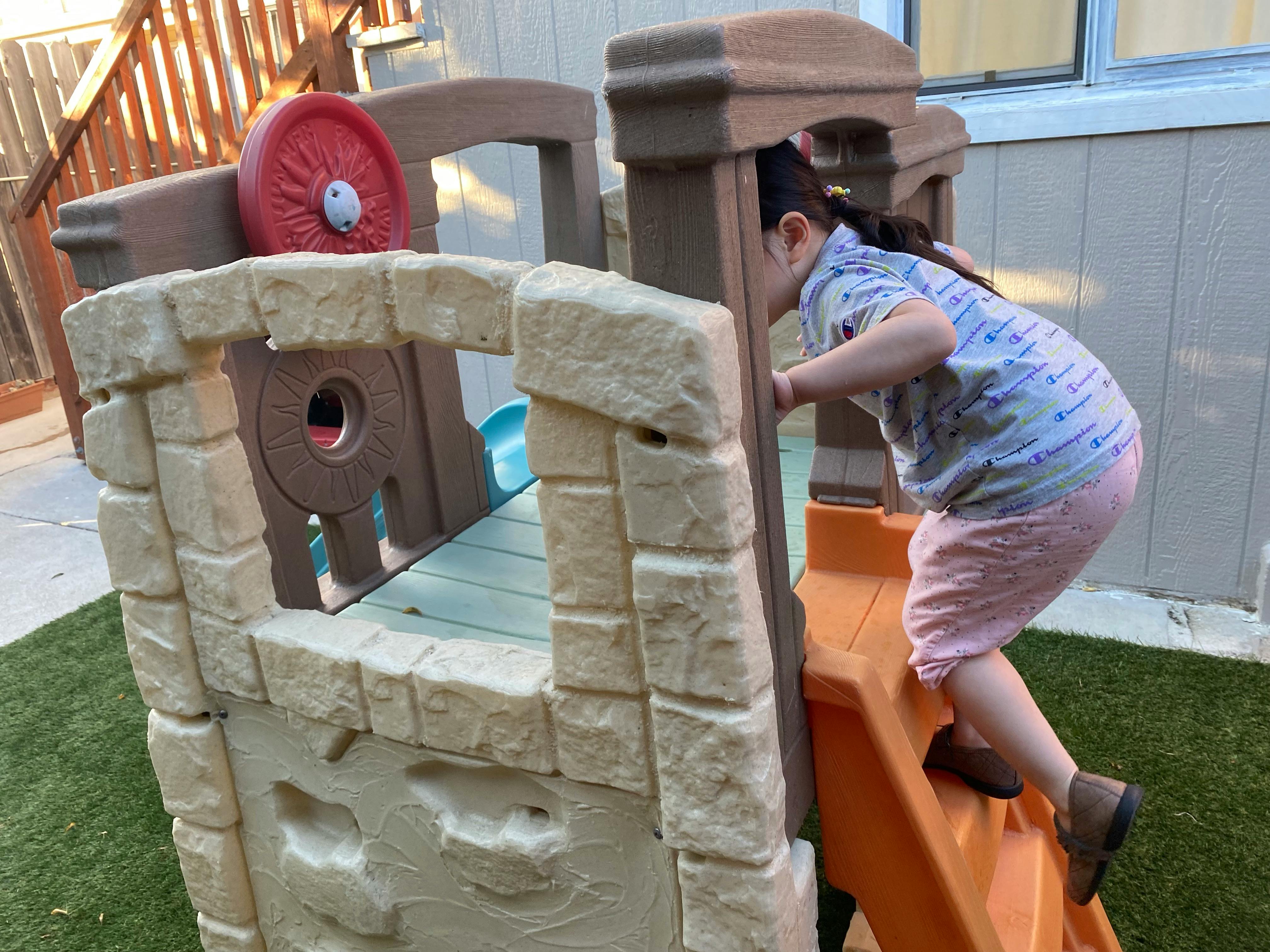 Child climbing up a play structure