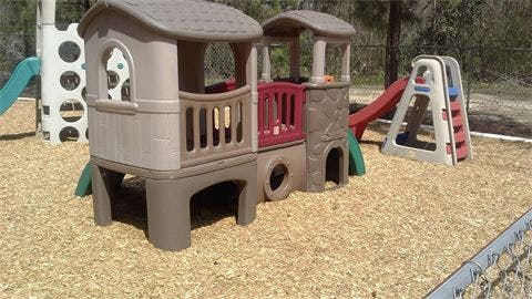Playground with playhouse structure and slide