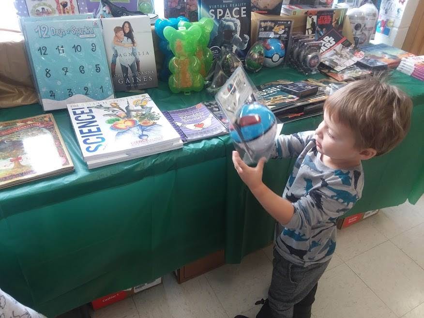 Child holding a toy next-generation robot toy