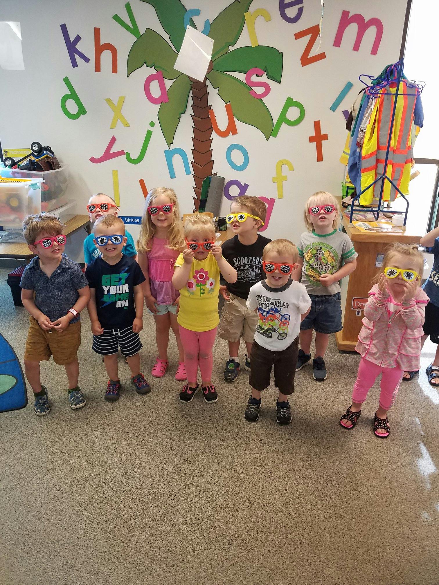 Group of children wearing novelty glasses in a classroom