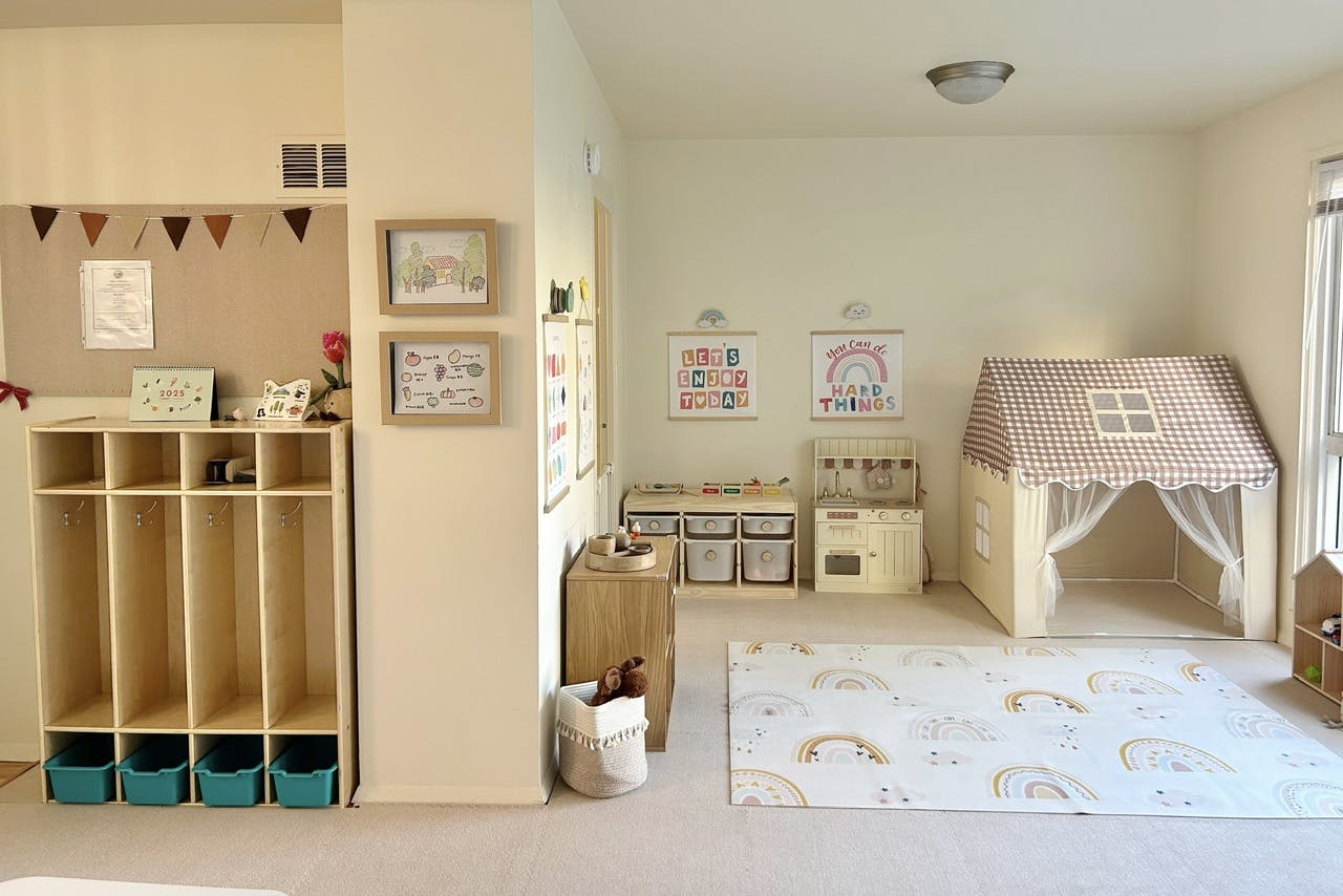 Playroom with cubbies, play kitchen, and a small playhouse