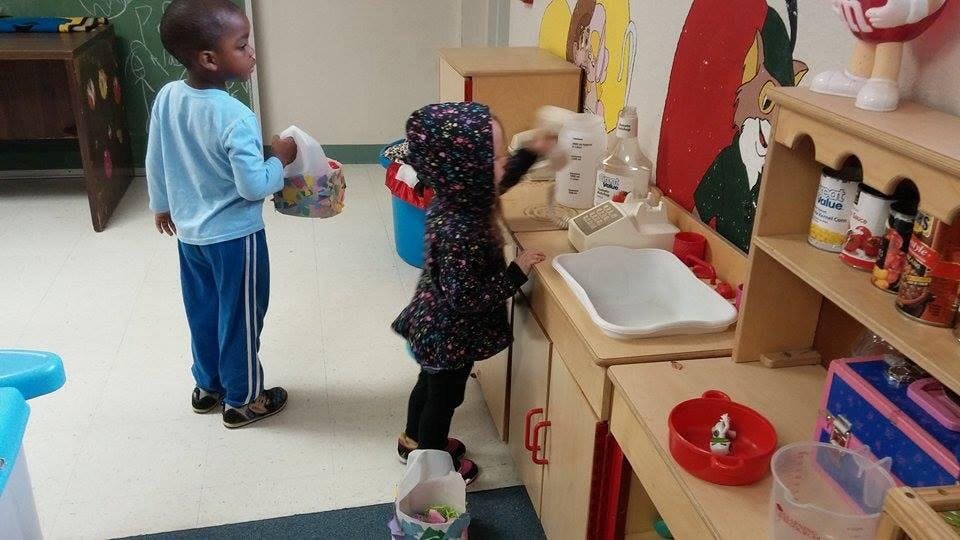 Two children playing in a classroom