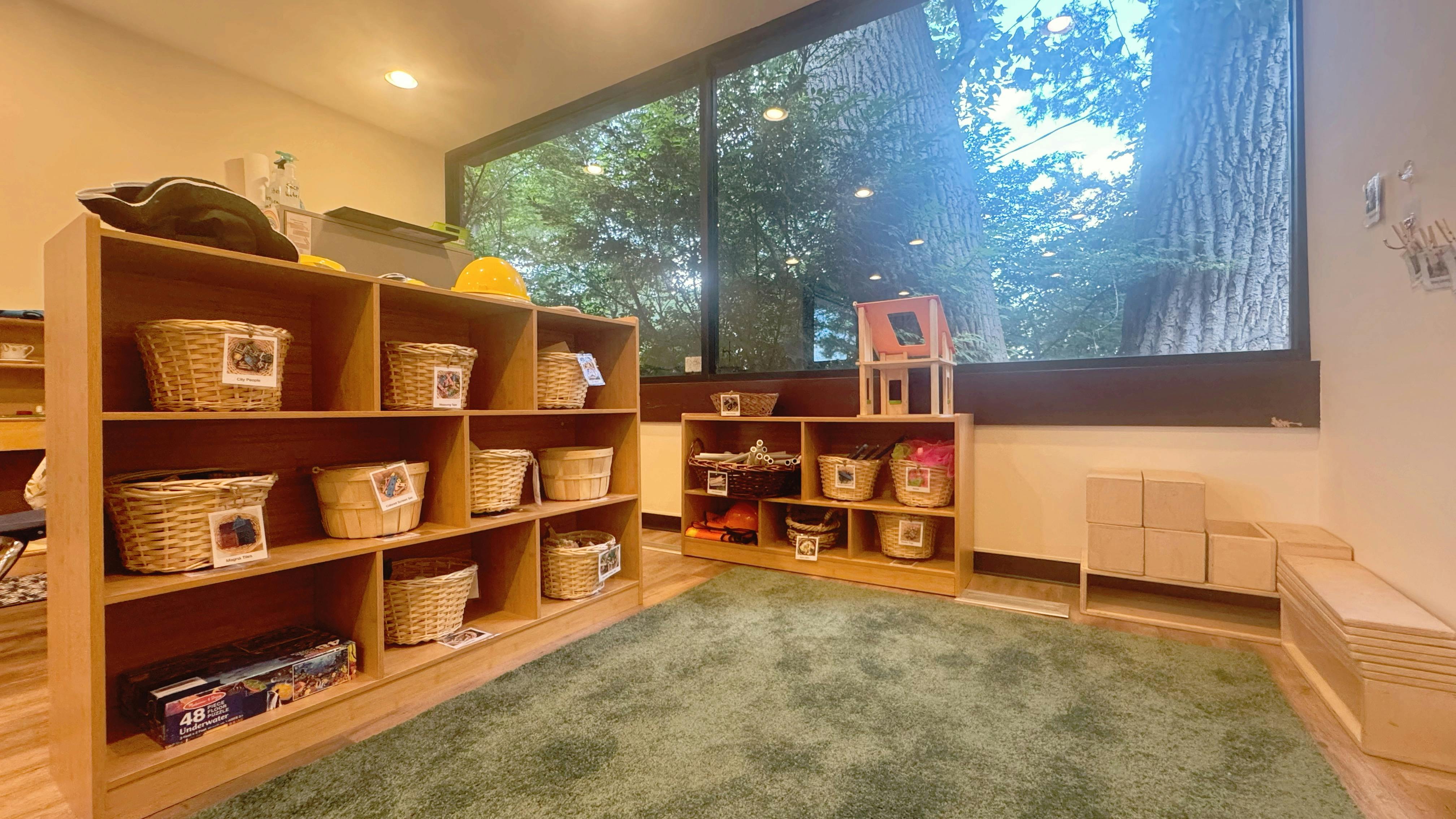 Classroom with wooden shelves, baskets, and a large window