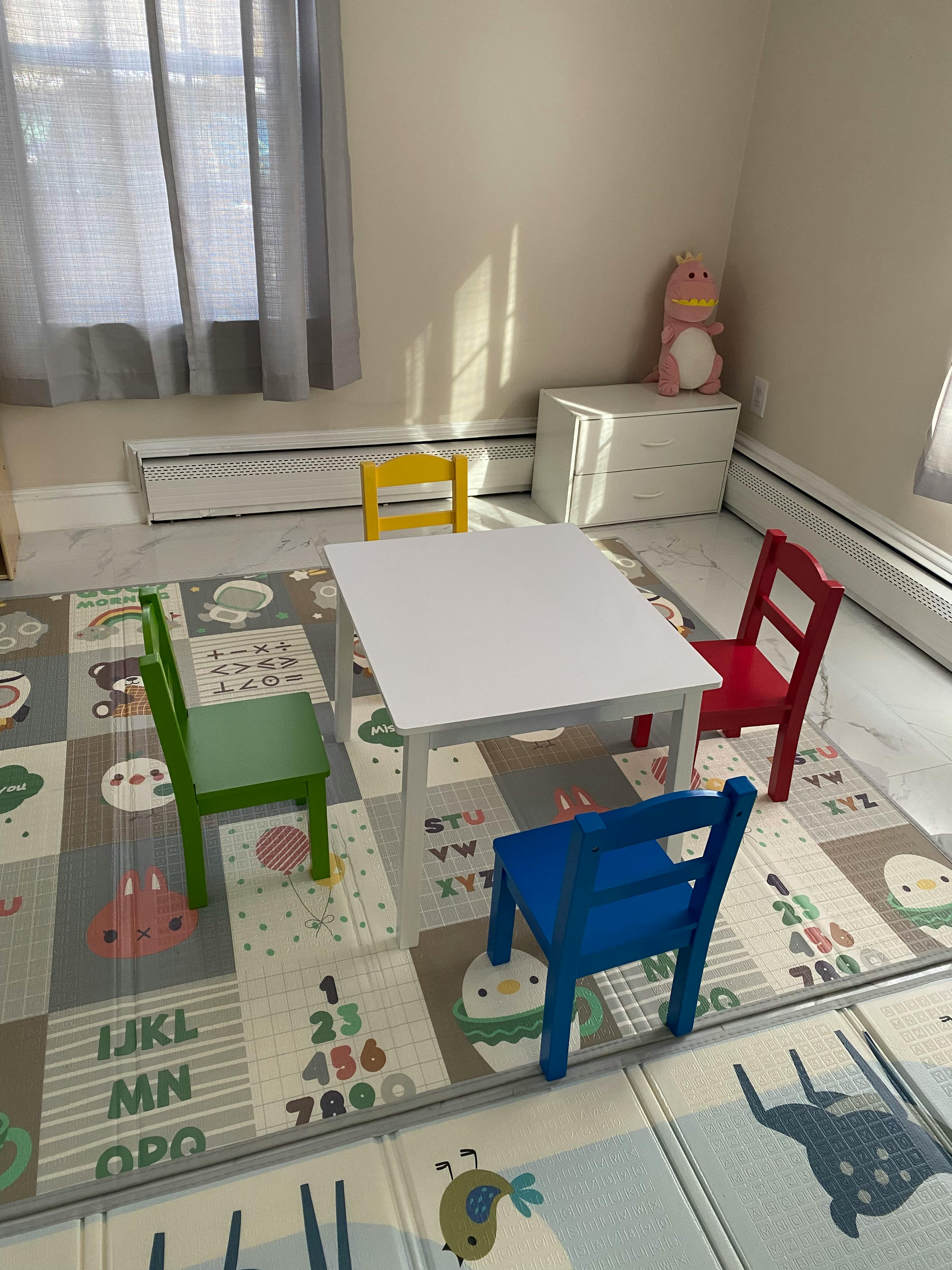 Children's table with four chairs on a playmat