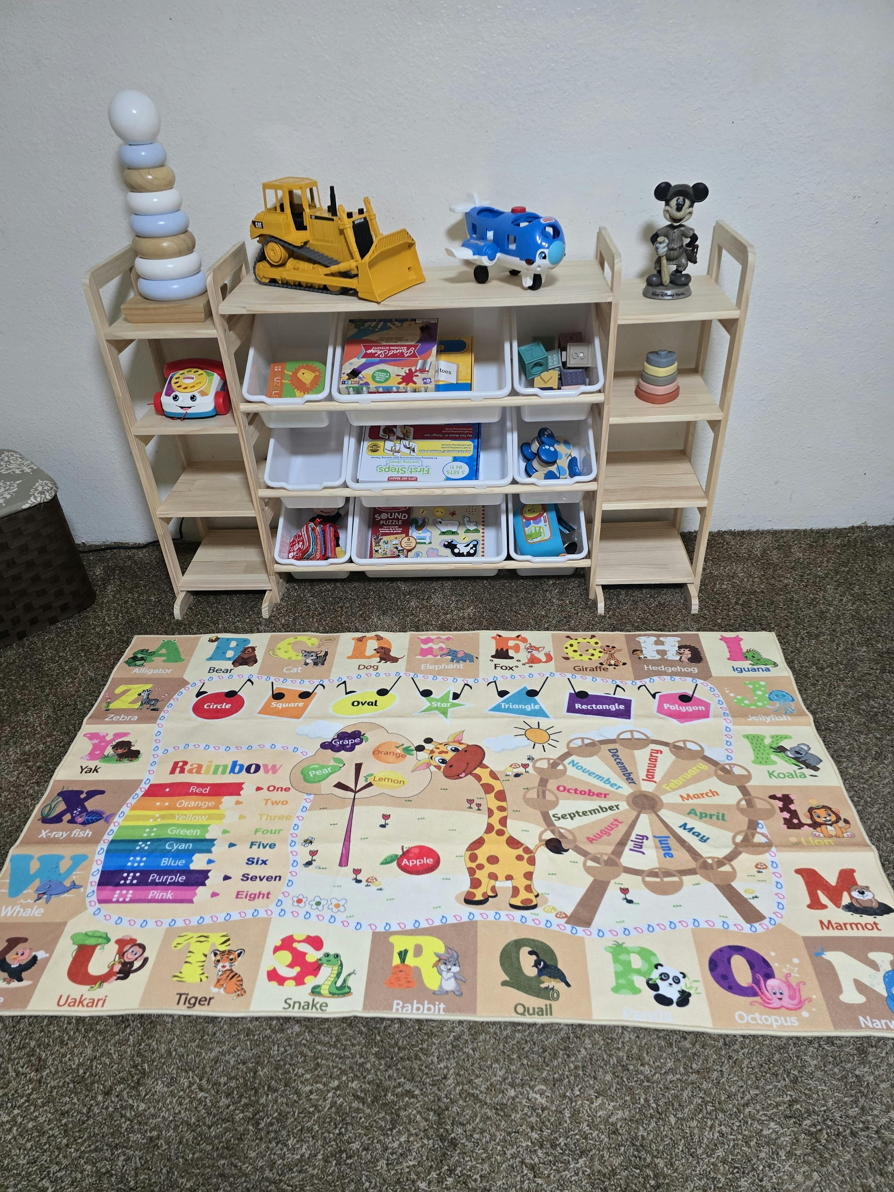 Child's playroom with a toy shelf and alphabet playmat on the floor