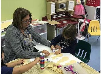 Adult and child doing crafts at a table