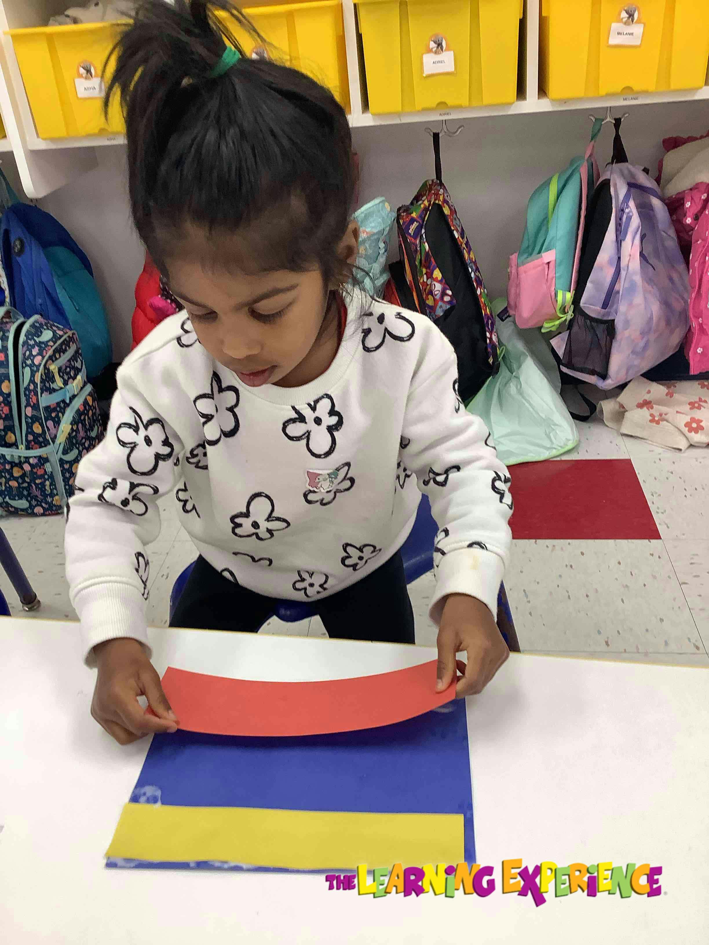 Child working with colorful paper