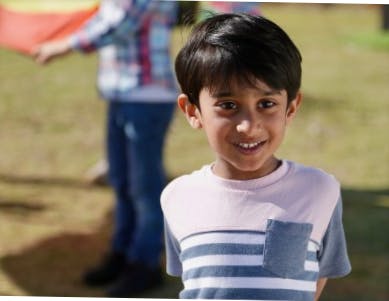 Child in a striped shirt smiling