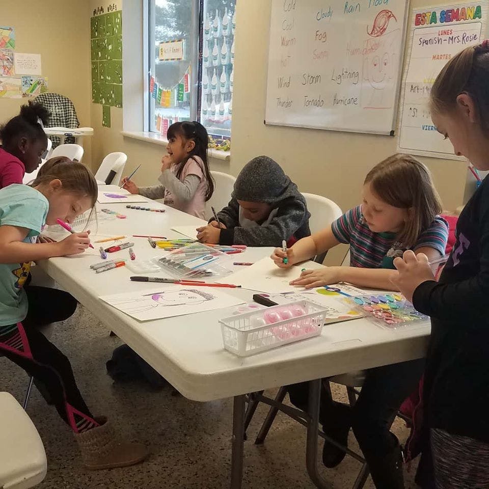 Children drawing and coloring at a table
