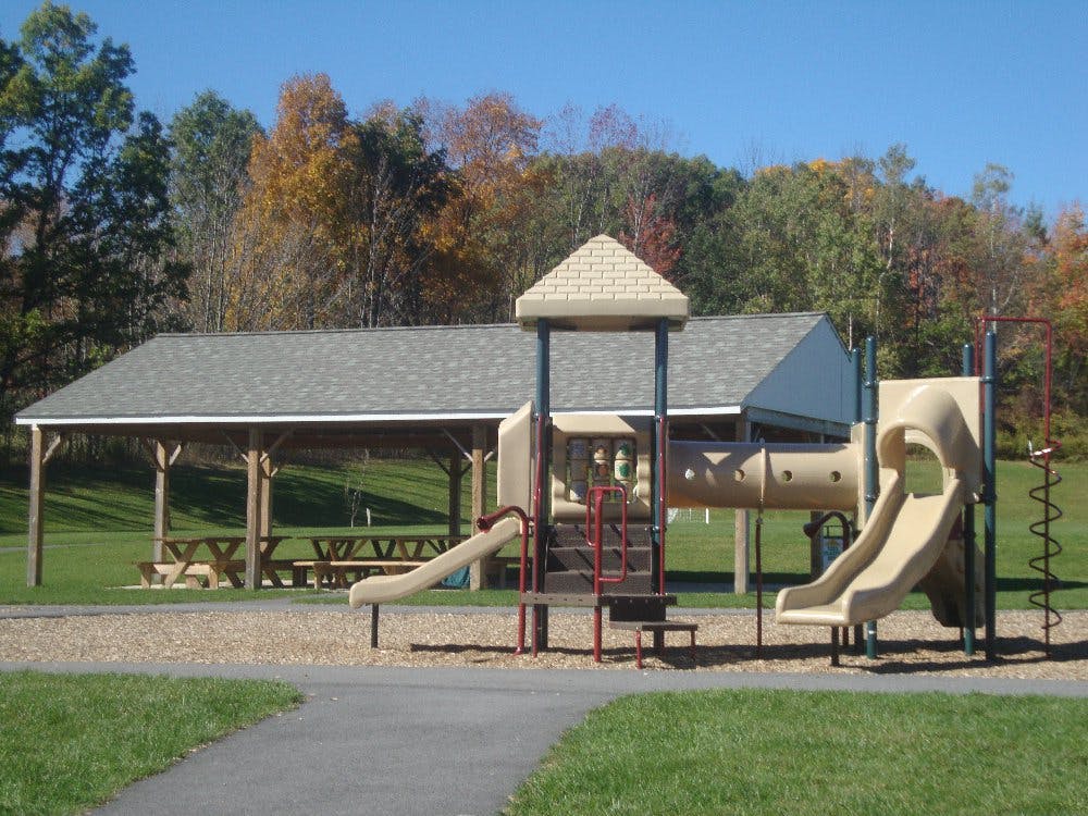 Playground with slides and tunnel next to a picnic pavilion