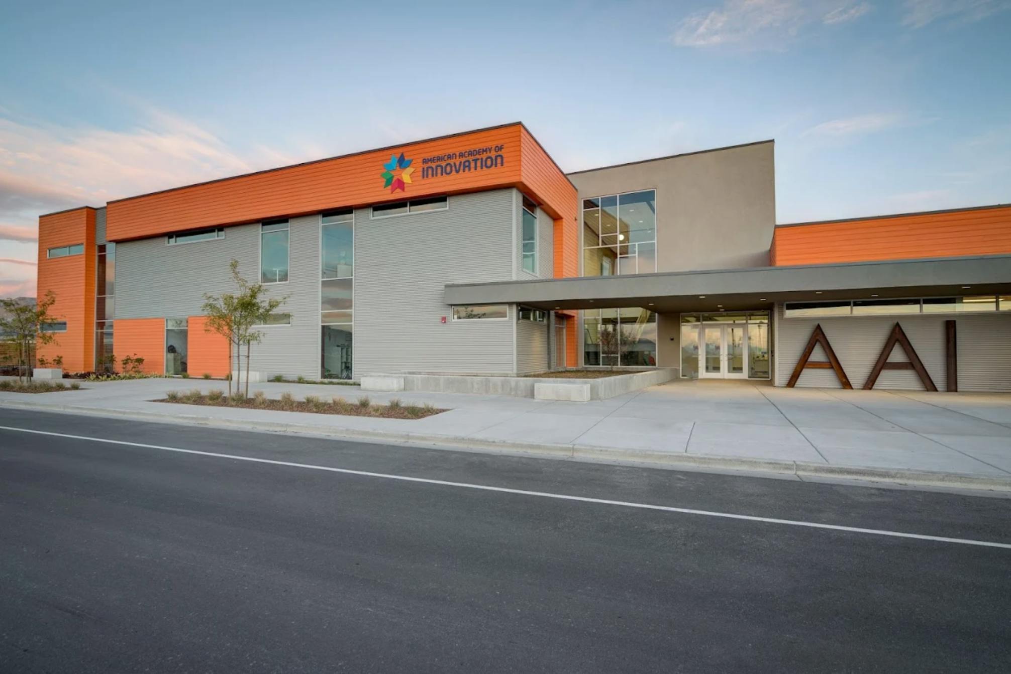 Modern building with orange and gray exterior, with "AAI" on the facade