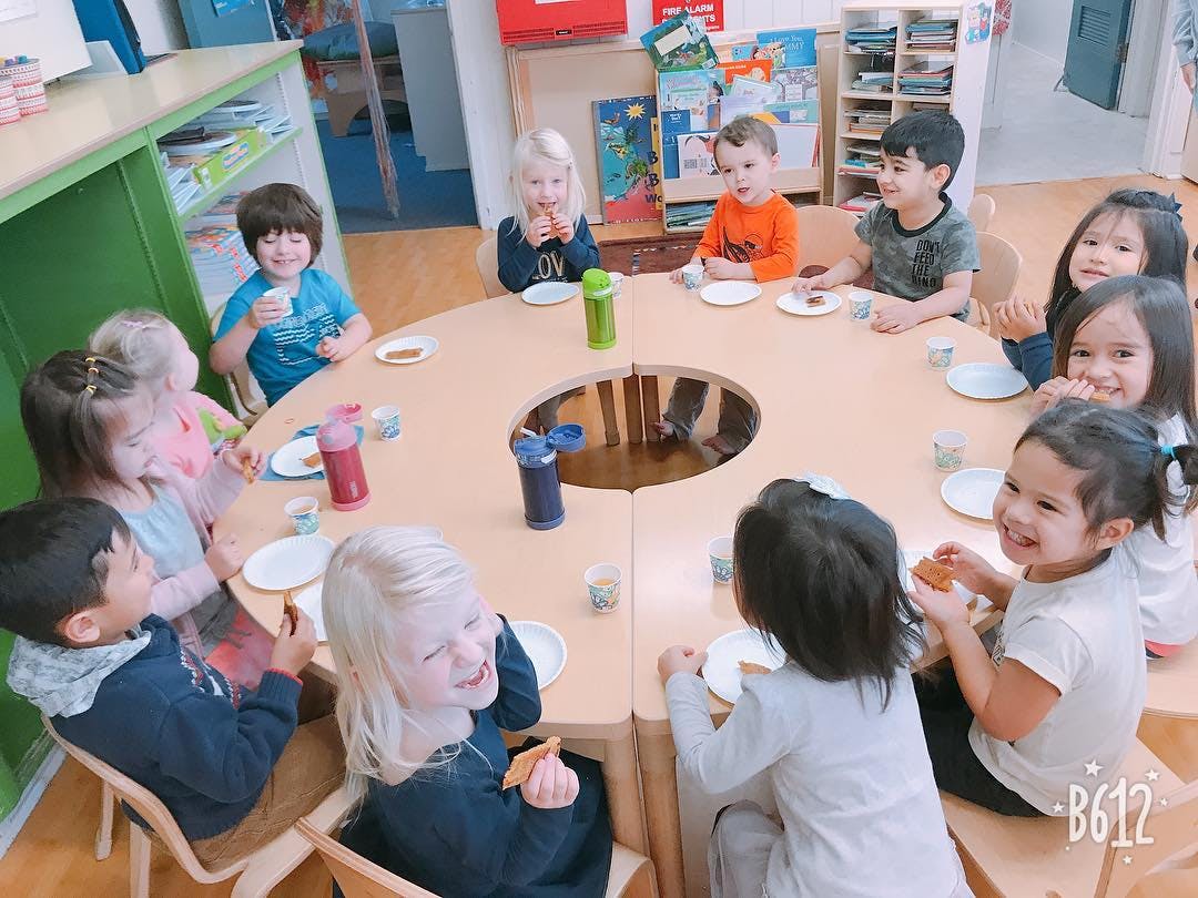 Children sitting around a circular table in a classroom