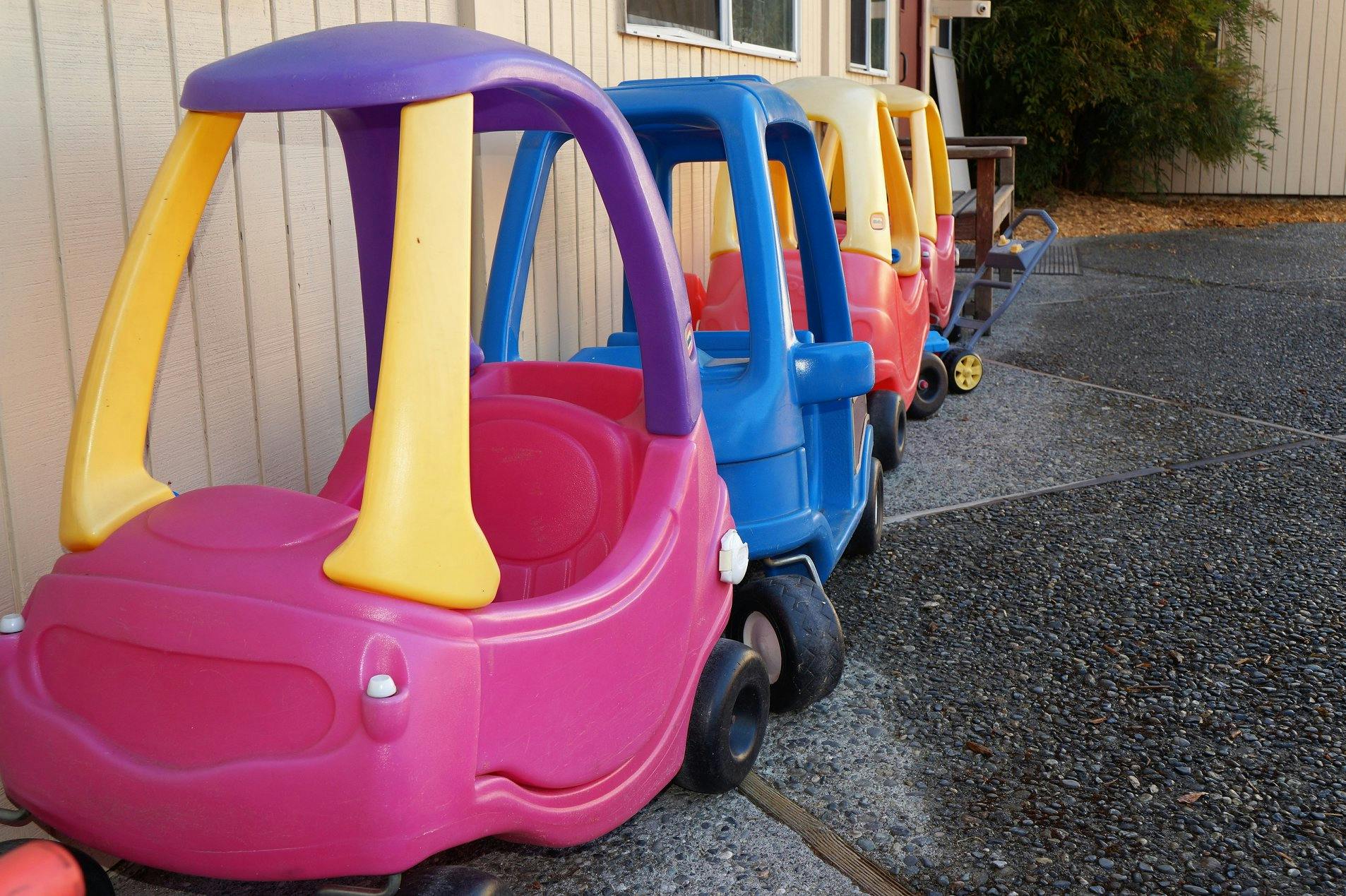 Row of colorful toy cars lined up