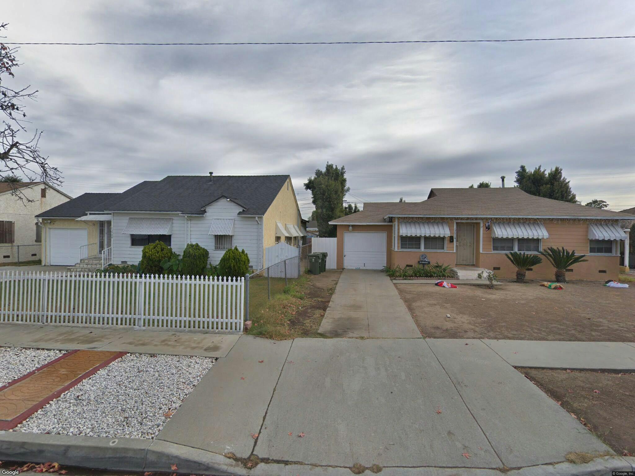 Two single-story houses with driveways and front yards