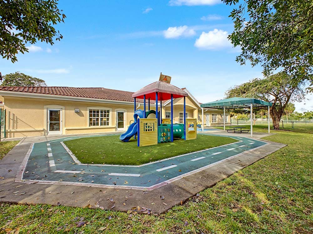 Playground with colorful play structure and green turf
