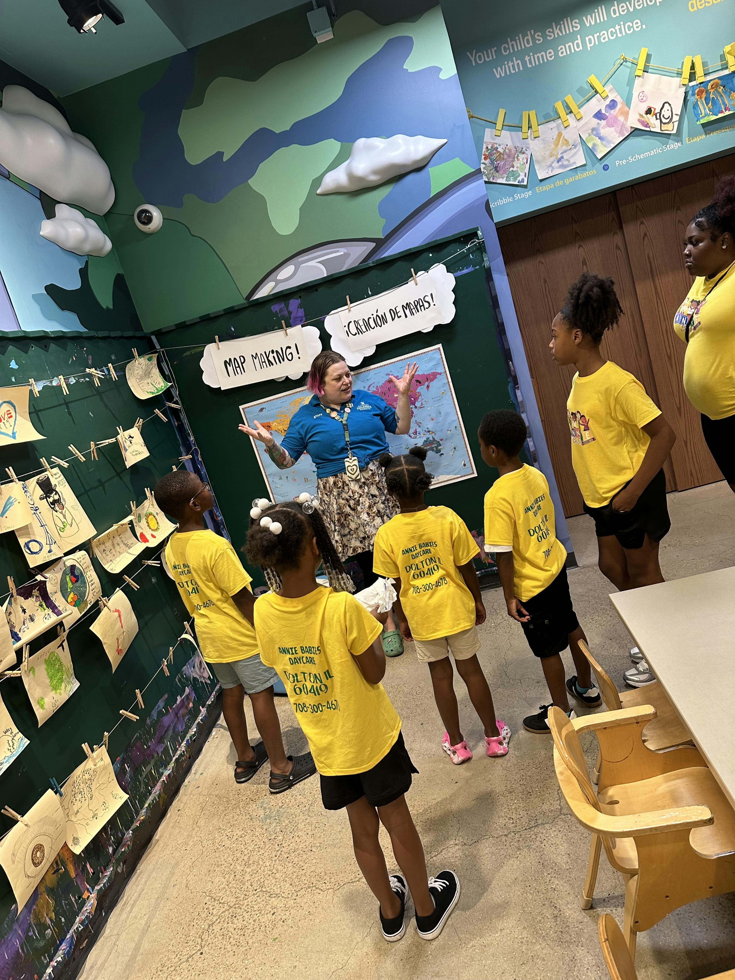Adult leading a map-making activity with five children