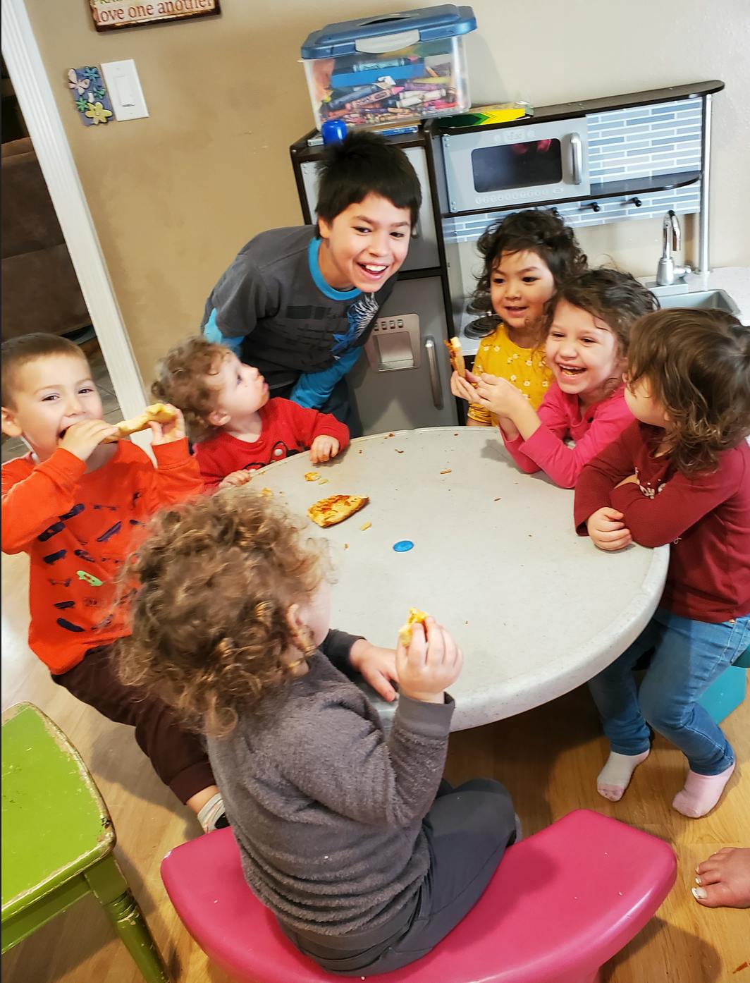 Group of children gathered around a table