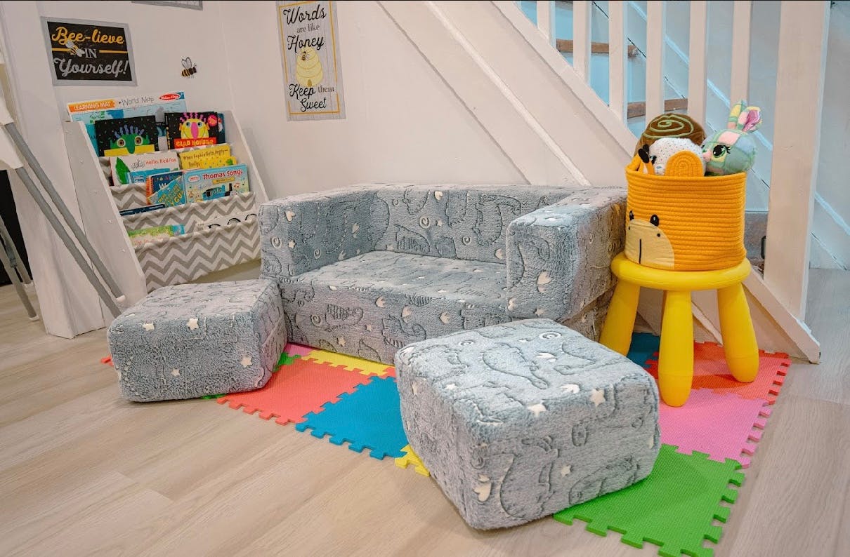 Children's play area with soft seating and colorful floor mats