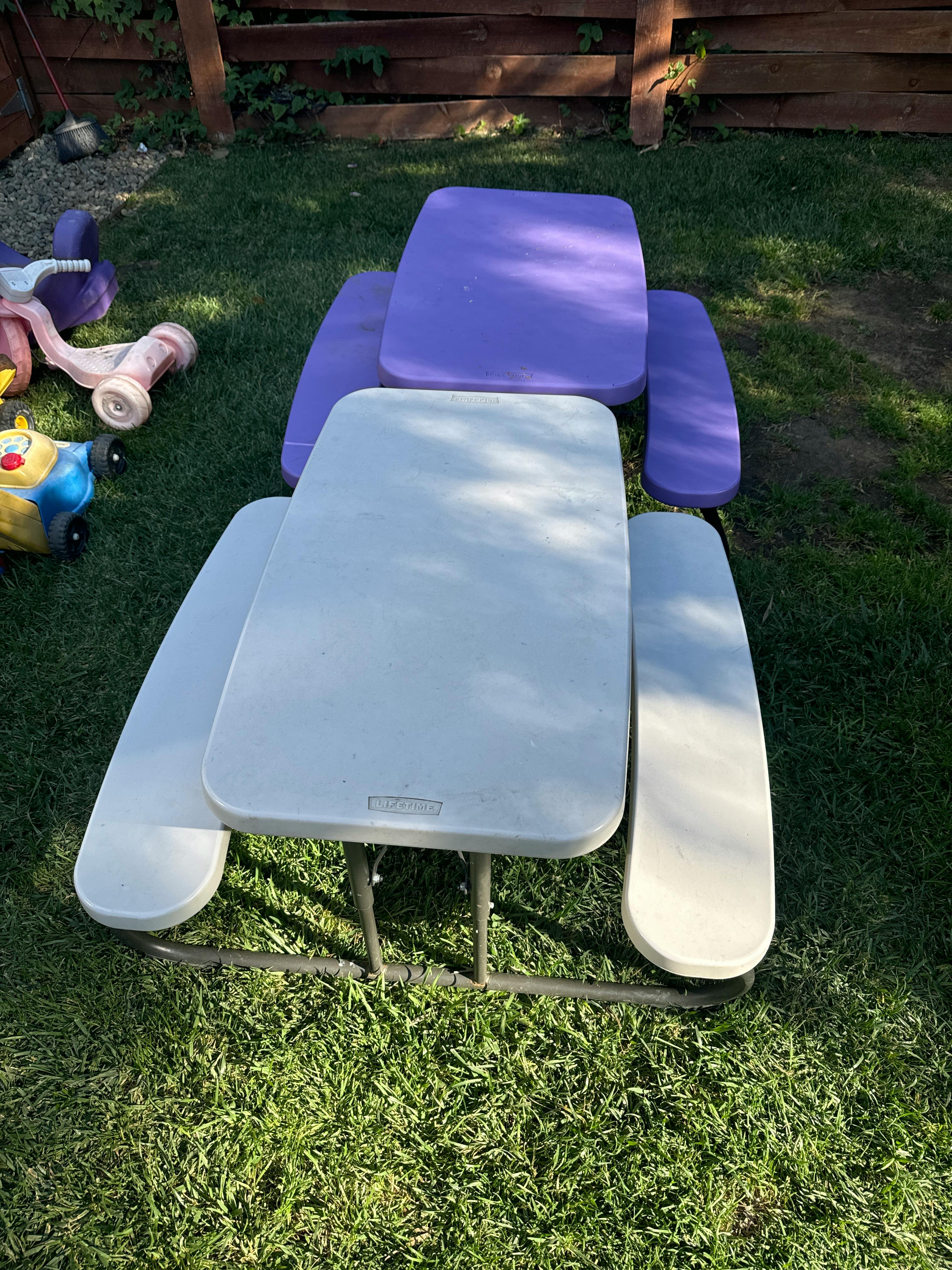White and purple picnic table on grass