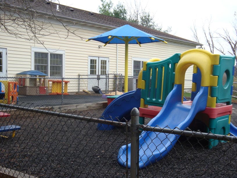Playground with slides and a blue umbrella