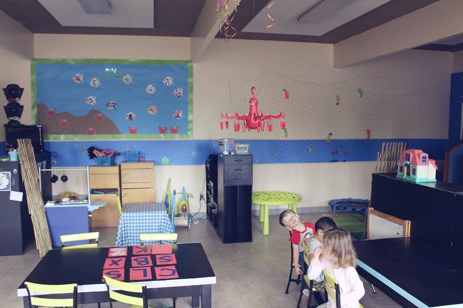 Children sitting at a table in a classroom