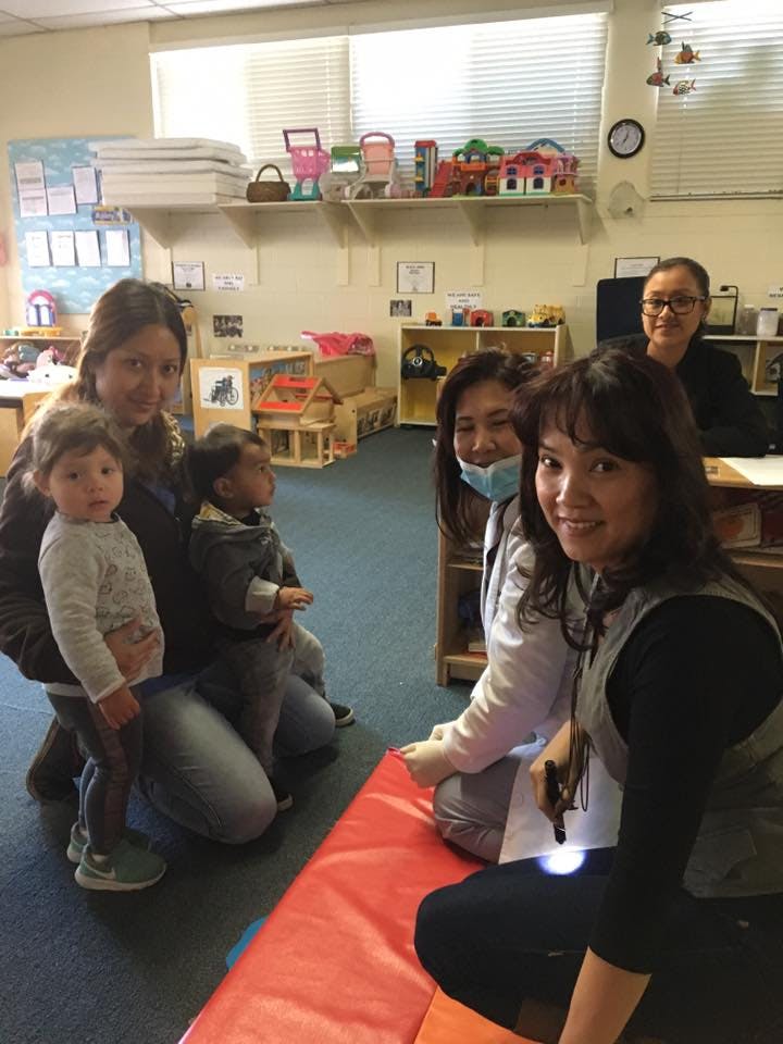 Adults and children in a classroom