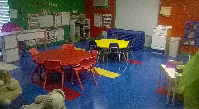 Classroom with red and yellow tables and chairs