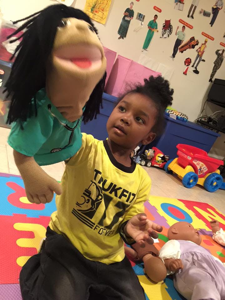 Child playing with a puppet