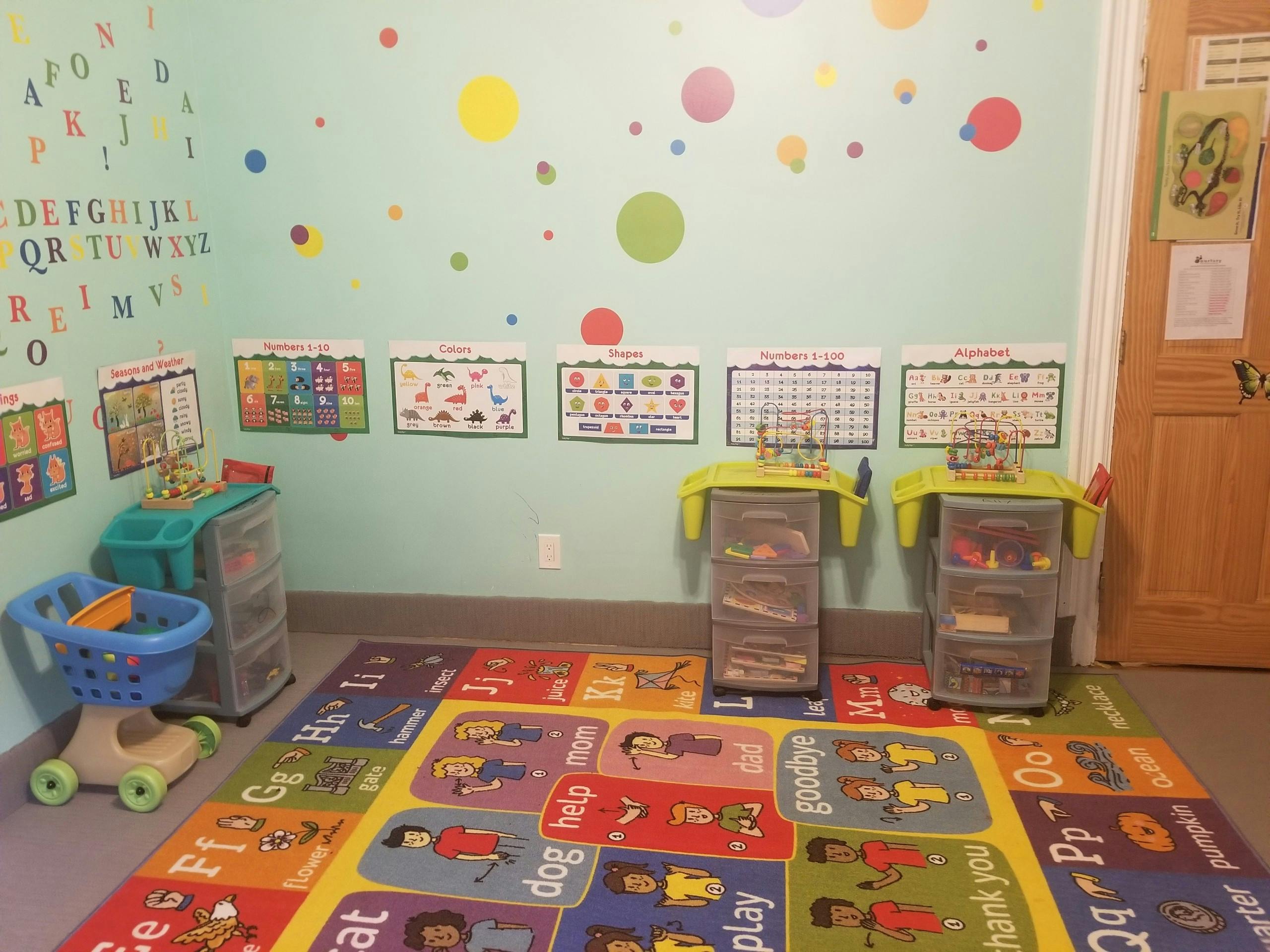 Classroom with alphabet rug, wall decorations, and storage units