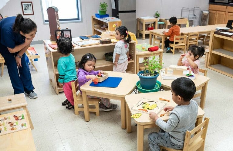 Adult and children in a classroom