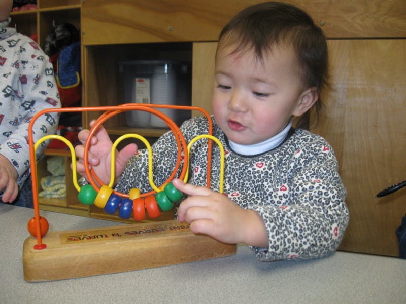 Child playing with a bead maze toy