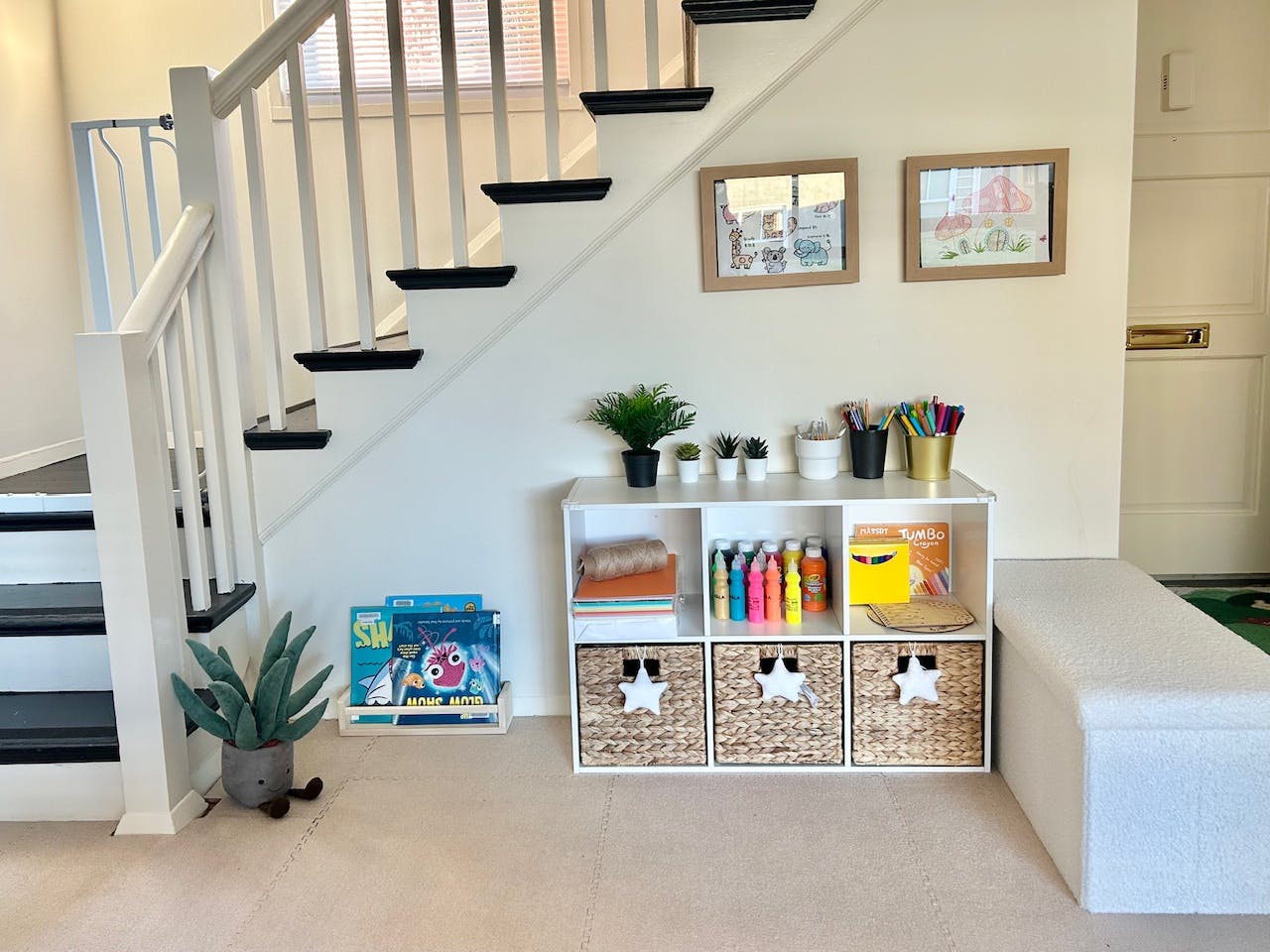 Staircase with white banister and black steps next to a white storage unit
