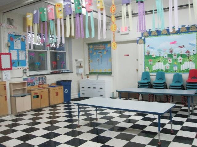Classroom with black and white checkered floor, tables, and chairs